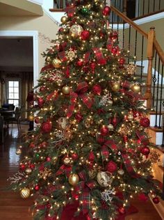 a decorated christmas tree with red and gold ornaments