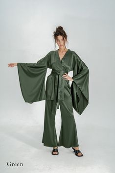 Indulge in the opulence of silk kimono pajamas, a sophisticated upgrade to your casual at-home attire. Drawing inspiration from the exquisite designs of traditional Japanese kimonos, our collection offers a fusion of comfort and elegance. Immerse yourself in the enduring allure of authentic Japanese traditions with our luxurious silk kimono line. ✂ About us: ♥ Est. 2017 ♥ Based in Lincolnshire, UK ♥ Handmade in Europe ♥ Small family run brand ♥ Handmade in Europe ♥ Sustainable and ethical production ♥ We support local craftsmanship ♥ Sizes for all body types ✂ About PJs: * Obi tie belt * Long wide kimono sleeves * Hidden side kimono pockets * Inside loops * High-waisted trousers *Trouser pockets * Silky Satin ✂ Shipping: * Fast UK delivery in 1 - 2 days * We ship worldwide! * Returns accep Japanese Pajamas Traditional, Bridal Kimono Robe, Long Bridal Robe, Bridal Dressing Gown, Silk Bridesmaid Robes, Pajamas Silk, Robe Silk, Kimono Pajamas, Bridal Kimono