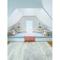 an attic bedroom with white walls and carpet