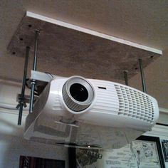 a white projector sitting on top of a ceiling