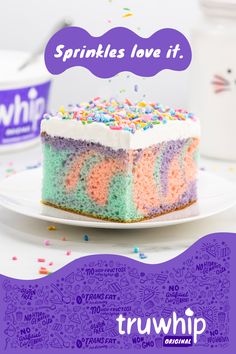 a slice of sprinkles love it cake on a white plate with purple lettering