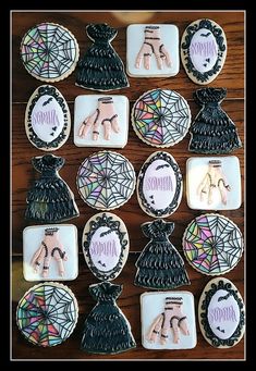 decorated cookies are arranged on a table with spider webs and handprinted designs