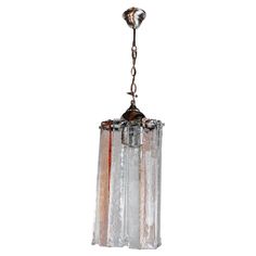 a glass light fixture hanging from a chain