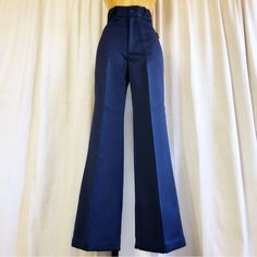 60s/70s Polished Navy High Waist Flare Wide Leg Bell Bottom Pants Deadstock Made Of Shiny, Satin-Look Polyester In Navy Blue. High Waist + Flared Bell Bottom Construction. X Shape Belt Loops! New With Tags! Size: 10 (But Please Refer To Measurements) Label: Put On (California) Waist: 25" Max Hips: 34" Max Rise: 13" Inseam: 28" Length: 40" Leg: Upper Thigh 10.5" (21" Doubled) // Cuff: 11" (22" Doubled) Fabric: 100% Poly Condition: Excellent! New With Tags! 70s Inspired Fitted Straight Leg Bottoms, Retro Blue Straight Leg Pants, Retro Blue Bottoms With Pockets, Retro Fitted High-waisted Wide Leg Pants, Retro Straight Pants For Work, 70s Inspired Fitted Full Length Pants, Retro High-waisted Bottoms For Workwear, Retro High-waisted Workwear Bottoms, Retro High Waist Bottoms For Work