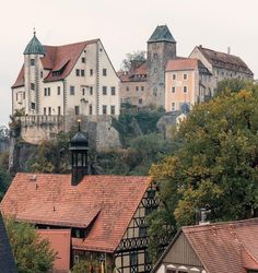 an old castle sits on top of a hill