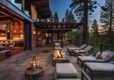 an outdoor living area with couches and fire pit