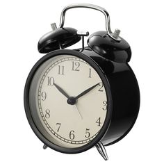 an alarm clock with two bells on each side and one bell at the top is black