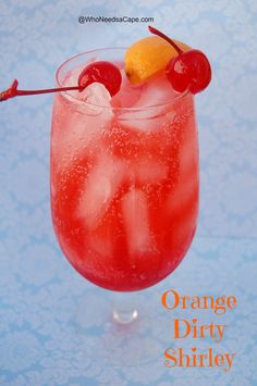 an orange drink in a glass with ice and cherries on the rim, garnished with a cherry