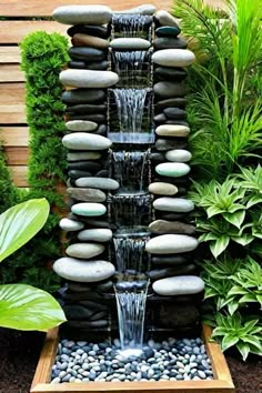 a water fountain surrounded by rocks and plants