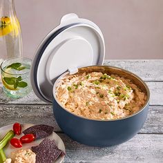 a bowl of hummus and crackers on a table