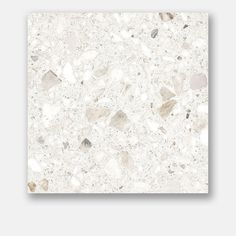 a white marble tile with small rocks on it