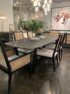 a dining room table with chairs and a bowl on it