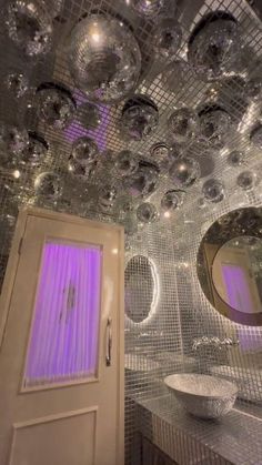 a bathroom with mirrored balls hanging from the ceiling