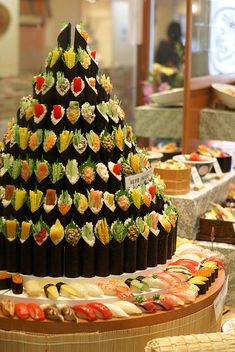 sushi platter with many different types of sushi on display in a restaurant