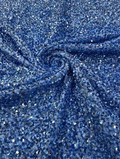 blue sequin fabric with silver glitters on it