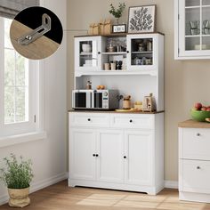 a kitchen with white cupboards and wooden flooring, along with an open window