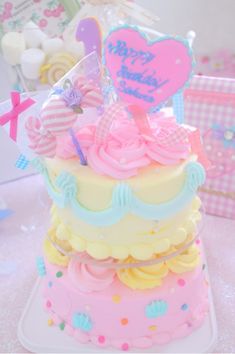 there is a cake that has been decorated with hearts and ribbons on it's top