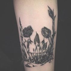 a black and white photo of flowers on the arm