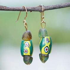 The exquisite artistry of the Ghanaian lands merges with Tina Quaye's love for the environment, creating these bold dangle earrings ideal for expressing your chic side. The artisan works with recycled glass beads to create each piece, adding a charming palette of green and yellow hues that will allow you to captivate everybody with a stylish grace. In addition, the earrings feature brass hooks. Brass Hooks, Yellow Hues, Tigers Eye Necklace, Recycled Glass Bead, Brass Hook, Tiger Eye Bracelet, Tiger Eye Beads, Bone Beads, Beaded Dangle Earrings