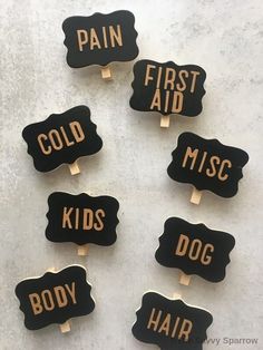 six black and gold pins with the words'first aid ','dog hair'and'first aid'written on them