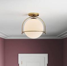 an empty room with a door and light fixture on the ceiling in front of it