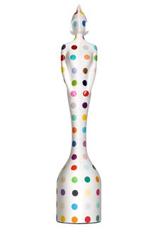 a white vase with multicolored dots on it's body and the shape of a woman's head