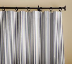 a black and white striped curtain hanging from a metal rod