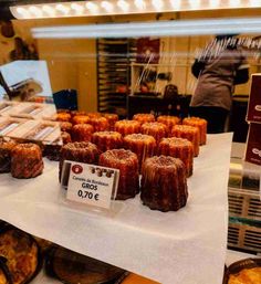 many different types of pastries on display in a store