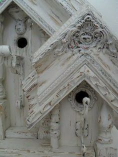 a birdhouse made out of wood and painted white