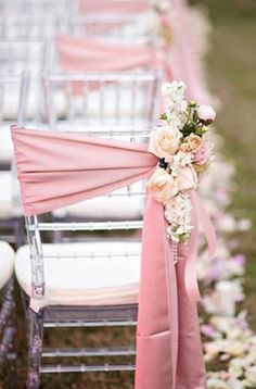 rows of chairs with pink sashes and white flowers