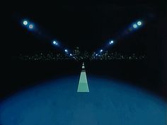 an empty road with bright lights at night