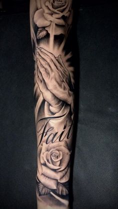 a person with a tattoo on their arm holding a rose and praying for the cross