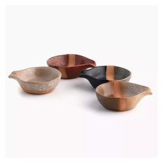 three bowls with different colors and designs on them, one is black, the other is brown