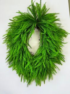 a green wreath is hanging on the wall