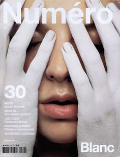 the cover of numero magazine features a woman with her hands on her face