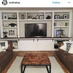 a living room filled with furniture and a flat screen tv mounted on a wall above a wooden coffee table