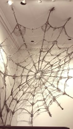 a spider web hanging from the ceiling in a room