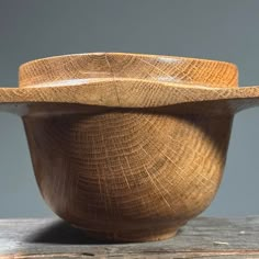 a wooden bowl sitting on top of a wooden table