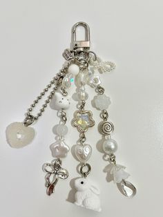 a key chain with various charms hanging from it's side on a white surface