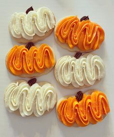 six decorated cookies arranged in the shape of pumpkins