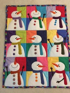 a colorful quilt with snowmen on it