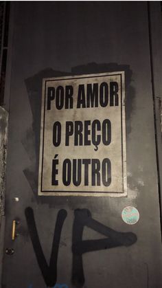 a sign that is on the side of a door with graffiti written in spanish and english