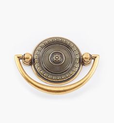 an antique brass door handle on a white background