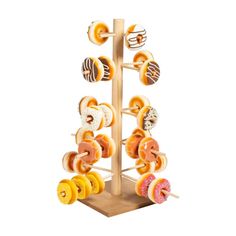 an assortment of donuts on a wooden stand