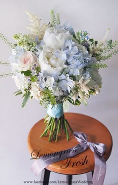 a bouquet of flowers sitting on top of a wooden table