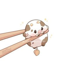 two chopsticks with an image of a cow on it's head and the word