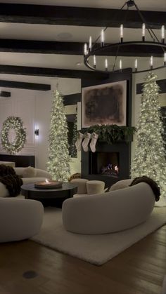 the living room is decorated for christmas with white trees and wreaths on the walls