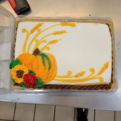 there is a cake decorated with flowers and pumpkins