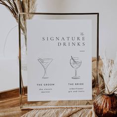 there is a sign that says signature drinks and the groom's cocktails are on display