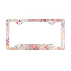 a license plate frame with flowers on the front and bottom, in pinks and yellows